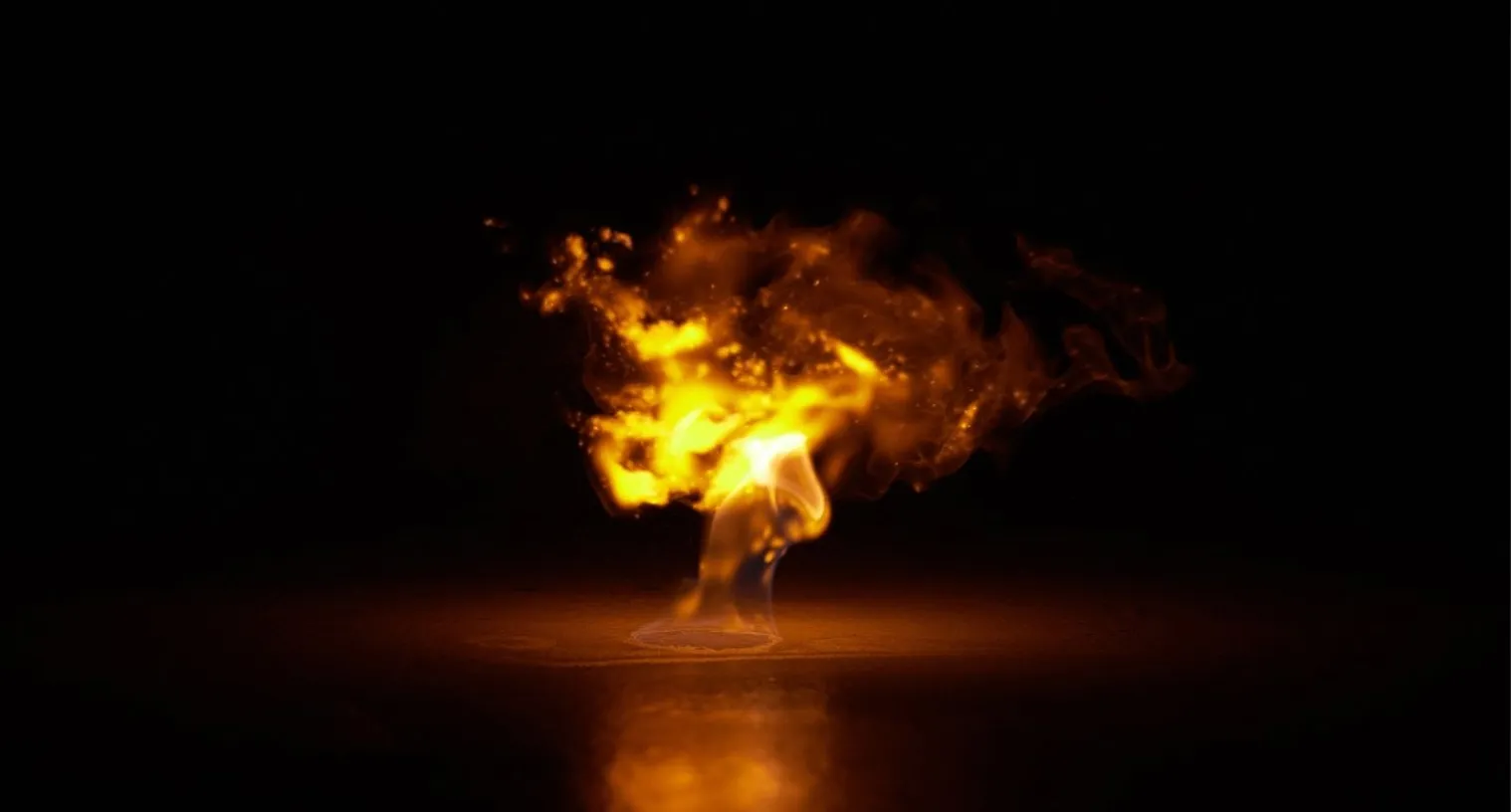 A burst of fire flaring up against darkness